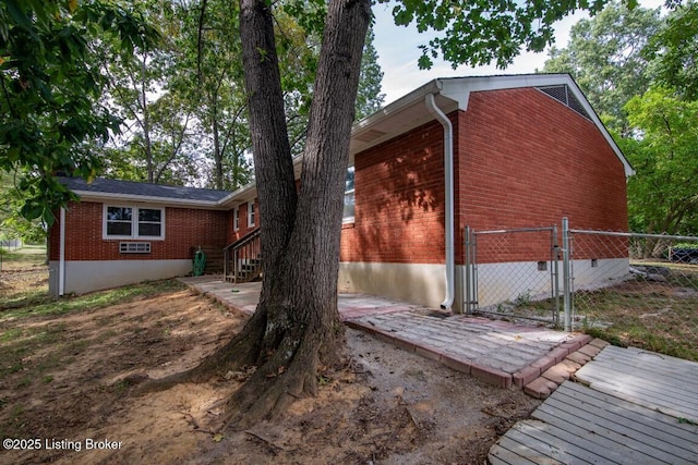 933 Lakeshore Pkwy, Brandenburg, KY 40108 - view of side of property featuring brick siding, a gate, and crawl space
