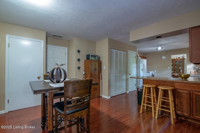 933 Lakeshore Pkwy, Brandenburg, KY 40108 - dining space featuring dark wood-style floors and a textured ceiling