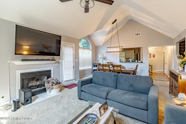 4101 Adelaide Ct, Louisville, KY 40241 - living room featuring a ceiling fan, a fireplace with flush hearth, high vaulted ceiling, and a chandelier