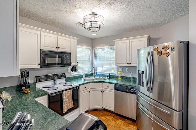 4101 Adelaide Ct, Louisville, KY 40241 - kitchen featuring appliances with stainless steel finishes, dark countertops, white cabinets, a textured ceiling, and a chandelier