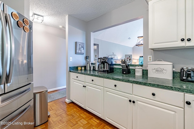 4101 Adelaide Ct, Louisville, KY 40241 - kitchen with freestanding refrigerator, dark countertops, white cabinetry, and a textured ceiling