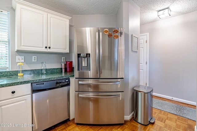 4101 Adelaide Ct, Louisville, KY 40241 - kitchen featuring stainless steel appliances, white cabinets, a textured ceiling, and dark countertops