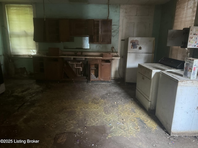 2617 Bank St, Louisville, KY 40212 - kitchen with freestanding refrigerator, independent washer and dryer, and brown cabinets