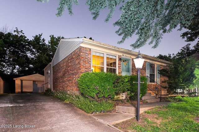 5709 Midnight Ln, Louisville, KY 40229 - view of front facade featuring brick siding, an outbuilding, and a garage