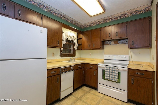 5709 Midnight Ln, Louisville, KY 40229 - kitchen with white appliances, light countertops, light flooring, and under cabinet range hood