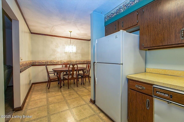 5709 Midnight Ln, Louisville, KY 40229 - kitchen with freestanding refrigerator, dishwasher, light flooring, a wainscoted wall, and a chandelier