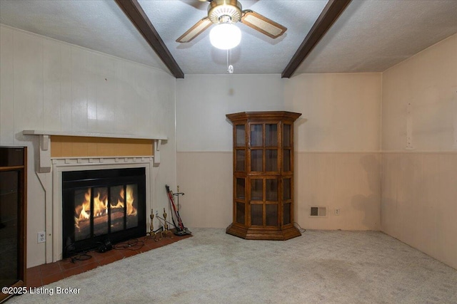 5709 Midnight Ln, Louisville, KY 40229 - unfurnished living room with beam ceiling, ceiling fan, carpet, a fireplace with flush hearth, and a wainscoted wall