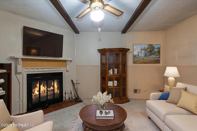 5709 Midnight Ln, Louisville, KY 40229 - carpeted living room with a ceiling fan, beam ceiling, and a fireplace with flush hearth