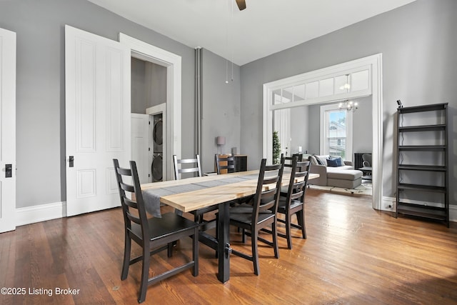 1080 Baxter Ave Unit 2, Louisville, KY 40204 - dining room featuring stacked washer / drying machine, wood finished floors, a ceiling fan, and a chandelier