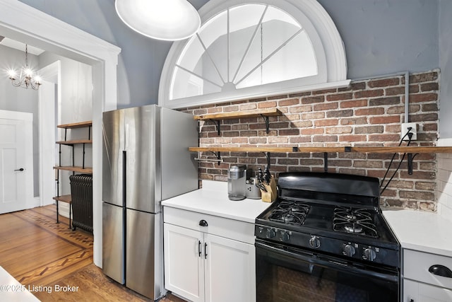 1080 Baxter Ave Unit 2, Louisville, KY 40204 - kitchen featuring black gas stove, freestanding refrigerator, a chandelier, open shelves, and light wood-style flooring