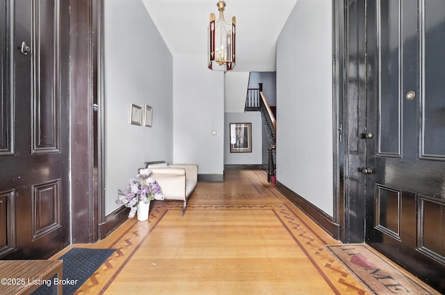 1080 Baxter Ave Unit 2, Louisville, KY 40204 - foyer entrance with a chandelier, wood finished floors, and stairs