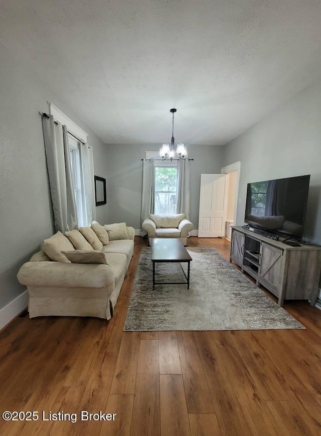 216 6th St, Carrollton, KY 41008 - living room with a chandelier and wood finished floors