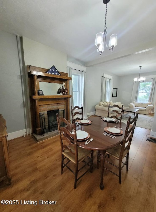 216 6th St, Carrollton, KY 41008 - dining area featuring a chandelier, wood finished floors, and a fireplace