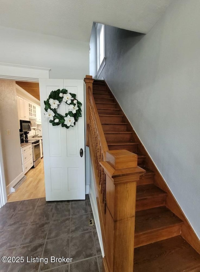 216 6th St, Carrollton, KY 41008 - staircase with tile patterned floors and baseboards