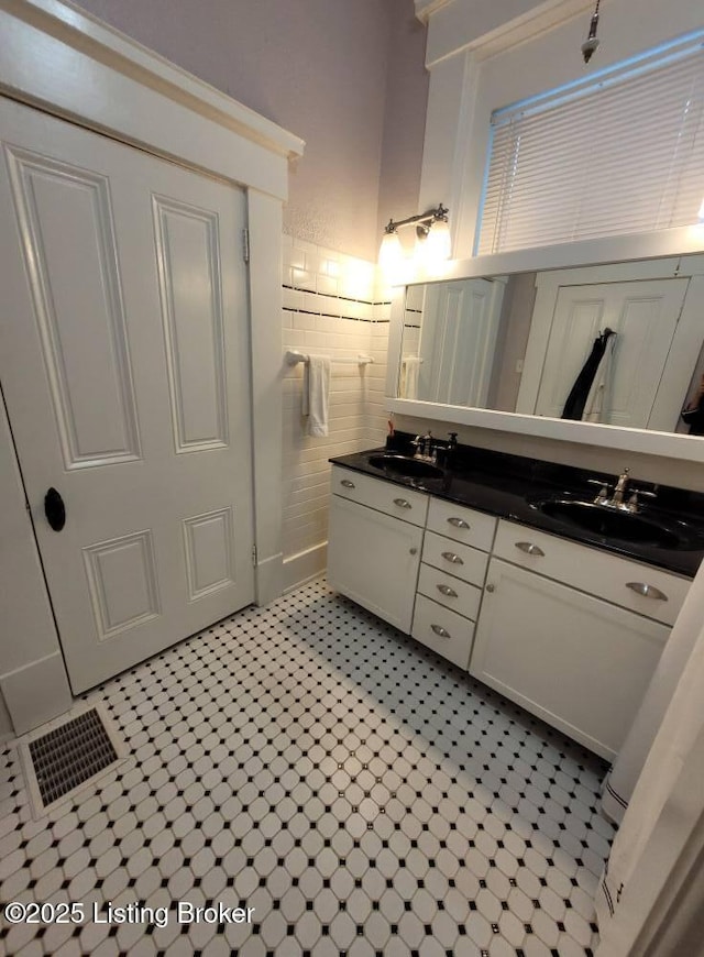 216 6th St, Carrollton, KY 41008 - bathroom with double vanity, tile patterned floors, and tile walls