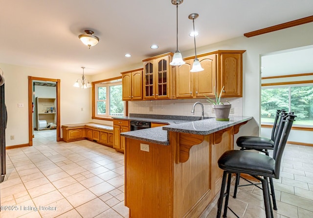 520 Ponder Dr, Shelbyville, KY 40065 - kitchen featuring a peninsula, light tile patterned floors, brown cabinetry, glass insert cabinets, and plenty of natural light