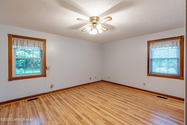 520 Ponder Dr, Shelbyville, KY 40065 - empty room with plenty of natural light, light wood finished floors, a ceiling fan, and a textured ceiling