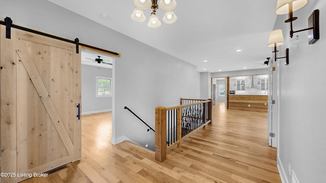 120 Lakelynn Ln, Shelbyville, KY 40065 - hall with an upstairs landing, a barn door, wood finished floors, a chandelier, and recessed lighting