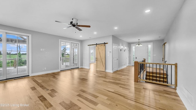 120 Lakelynn Ln, Shelbyville, KY 40065 - unfurnished living room featuring a barn door, light wood-type flooring, recessed lighting, a ceiling fan, and a chandelier