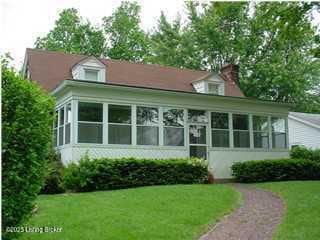 1852 Cypress St, Louisville, KY 40210 - rear view of house with a sunroom and a lawn