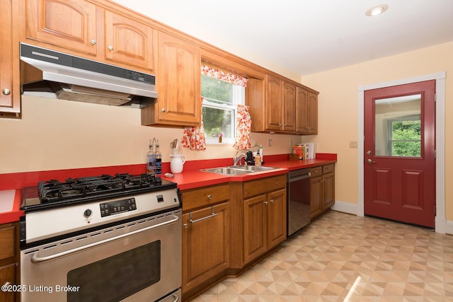 2309 Payne St, Louisville, KY 40206 - kitchen featuring appliances with stainless steel finishes, under cabinet range hood, healthy amount of natural light, and light floors