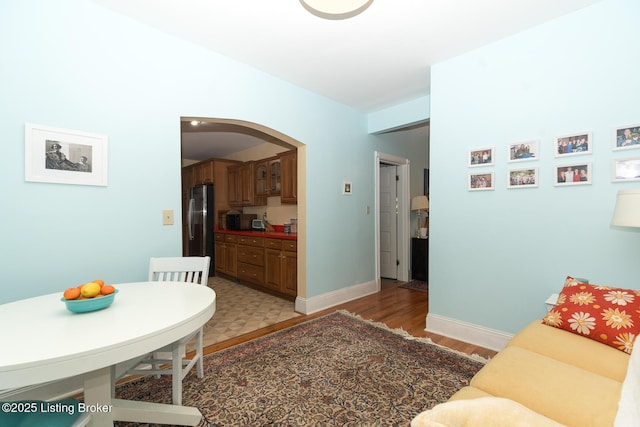 2309 Payne St, Louisville, KY 40206 - living area featuring arched walkways, light wood-type flooring, and lofted ceiling