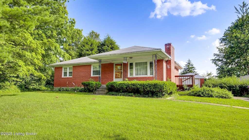 9706 Seatonville Rd, Louisville, KY 40291 - view of front of house featuring a chimney, a front yard, and brick siding