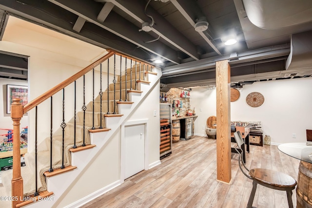 4025 Elmwood Ave, Louisville, KY 40207 - finished below grade area with a bar, wood finished floors, and stairway