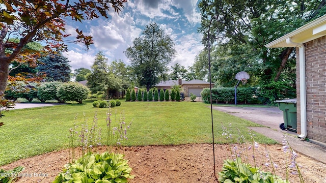1810 Bainbridge Row Dr, Louisville, KY 40207 - view of green lawn with driveway and a garage