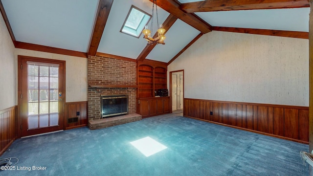 1810 Bainbridge Row Dr, Louisville, KY 40207 - unfurnished living room featuring a wainscoted wall, built in shelves, a brick fireplace, wood walls, and a chandelier