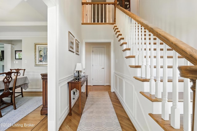 1375 Waxwing Pl, Louisville, KY 40223 - entryway featuring ornamental molding, stairway, light wood finished floors, a decorative wall, and wainscoting