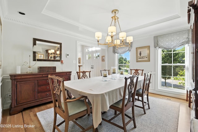 1375 Waxwing Pl, Louisville, KY 40223 - dining room featuring a raised ceiling, a chandelier, light wood finished floors, and crown molding