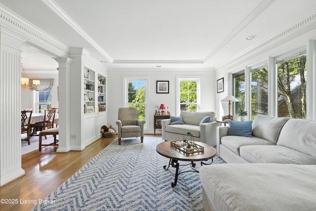 1375 Waxwing Pl, Louisville, KY 40223 - living area featuring wood finished floors, a raised ceiling, a chandelier, decorative columns, and crown molding