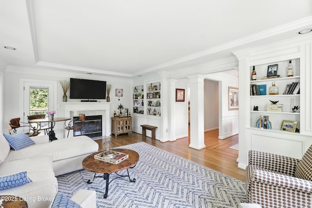 1375 Waxwing Pl, Louisville, KY 40223 - living room featuring wood finished floors, ornamental molding, a fireplace with flush hearth, built in shelves, and decorative columns
