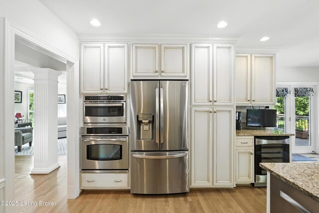 1375 Waxwing Pl, Louisville, KY 40223 - kitchen with appliances with stainless steel finishes, beverage cooler, decorative columns, light wood finished floors, and recessed lighting