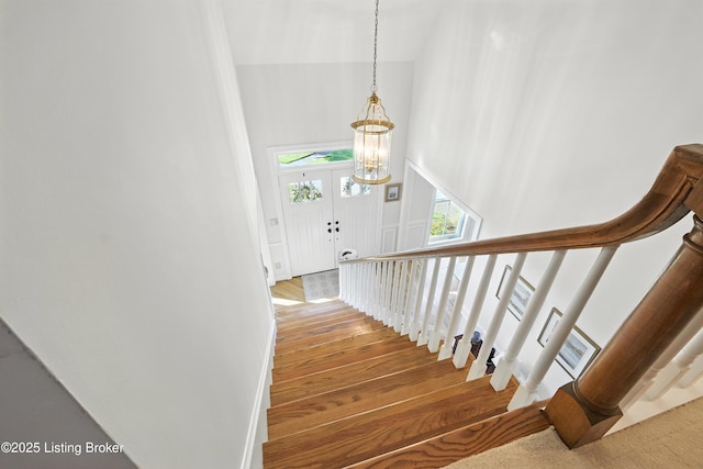 1375 Waxwing Pl, Louisville, KY 40223 - stairs featuring wood finished floors, a high ceiling, and a chandelier