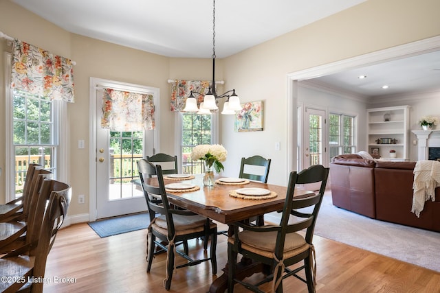 11731 Paramont Way, Prospect, KY 40059 - dining area featuring crown molding, light wood finished floors, and a chandelier