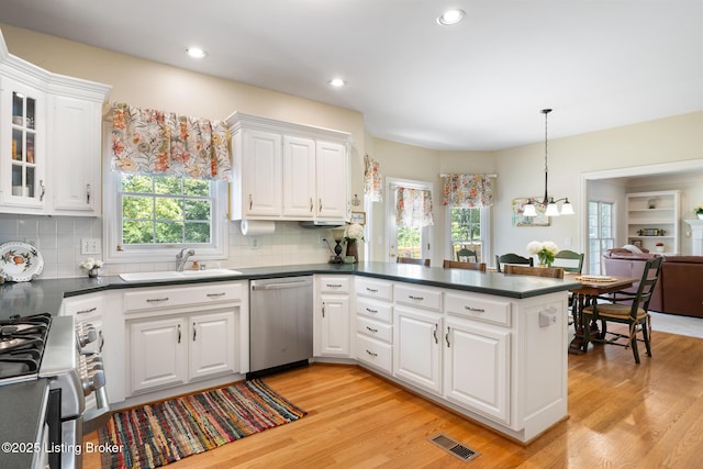 11731 Paramont Way, Prospect, KY 40059 - kitchen with appliances with stainless steel finishes, dark countertops, a peninsula, white cabinets, and recessed lighting