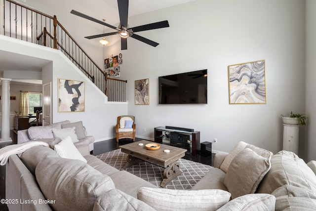 18007 Ellerslie Dr, Louisville, KY 40245 - living room with ceiling fan, ornate columns, a towering ceiling, wood finished floors, and stairs