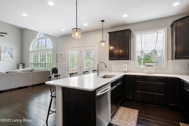 18007 Ellerslie Dr, Louisville, KY 40245 - kitchen with dishwasher, open floor plan, a breakfast bar, dark wood-style flooring, and a peninsula
