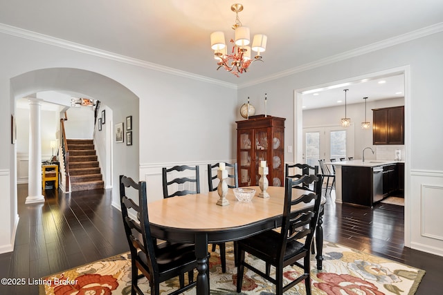 18007 Ellerslie Dr, Louisville, KY 40245 - dining area featuring wood-type flooring, a chandelier, arched walkways, crown molding, and stairway