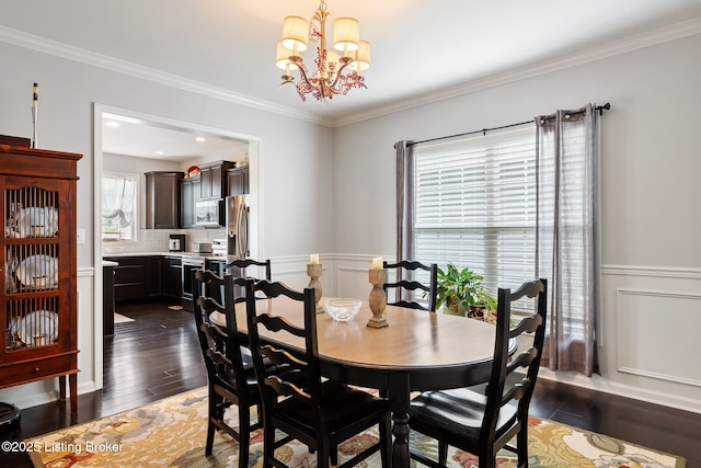 18007 Ellerslie Dr, Louisville, KY 40245 - dining area with a chandelier, dark wood finished floors, a wainscoted wall, ornamental molding, and a decorative wall
