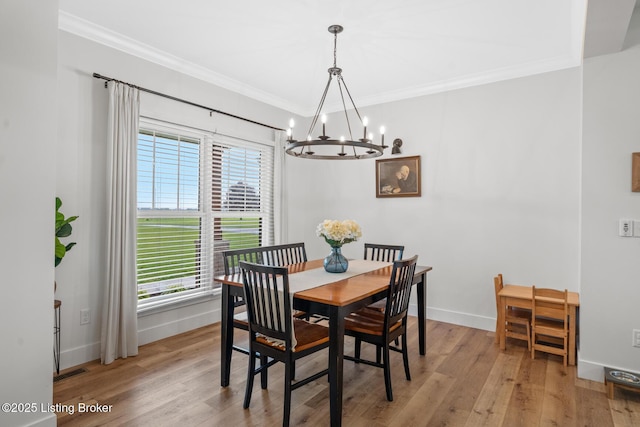 2070 Tonieville Rd, Hodgenville, KY 42748 - dining space featuring a chandelier, crown molding, and light wood-style flooring