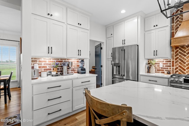 2070 Tonieville Rd, Hodgenville, KY 42748 - kitchen featuring appliances with stainless steel finishes, white cabinets, decorative backsplash, recessed lighting, and light stone counters