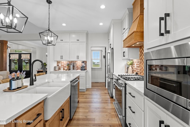 2070 Tonieville Rd, Hodgenville, KY 42748 - kitchen featuring appliances with stainless steel finishes, custom range hood, a chandelier, recessed lighting, and decorative backsplash