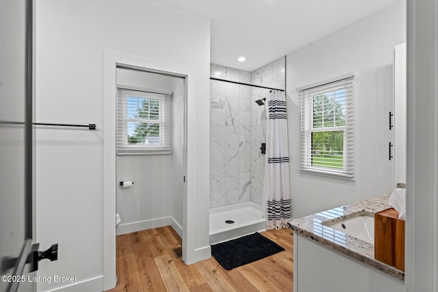 2070 Tonieville Rd, Hodgenville, KY 42748 - bathroom with plenty of natural light, a marble finish shower, vanity, wood finished floors, and recessed lighting