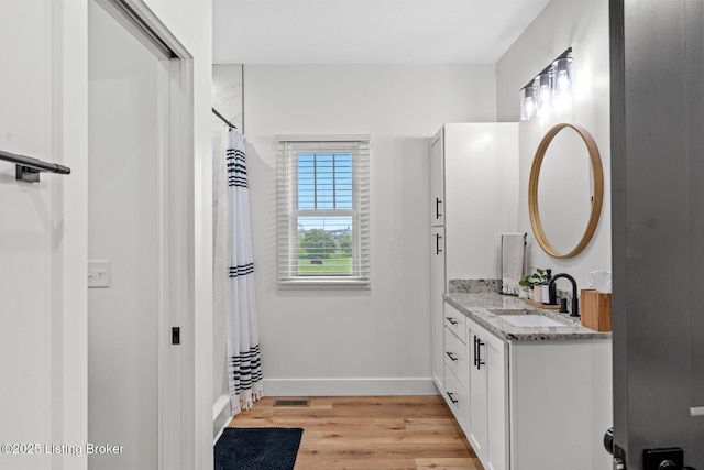 2070 Tonieville Rd, Hodgenville, KY 42748 - bathroom featuring vanity, wood finished floors, and curtained shower