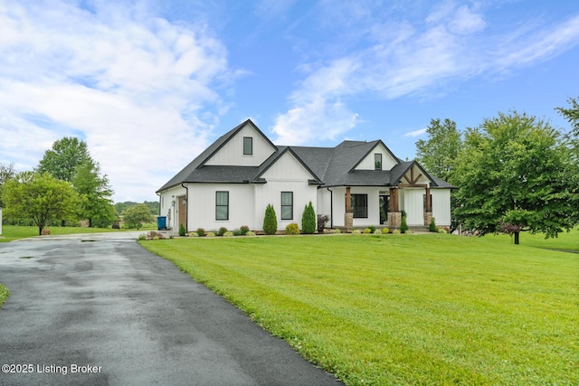 2070 Tonieville Rd, Hodgenville, KY 42748 - modern farmhouse style home with board and batten siding, a front yard, driveway, and a porch