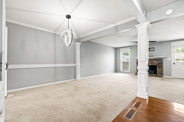10505 Kovats Ct, Louisville, KY 40223 - unfurnished living room featuring ornate columns, carpet floors, a brick fireplace, wood finished floors, and crown molding