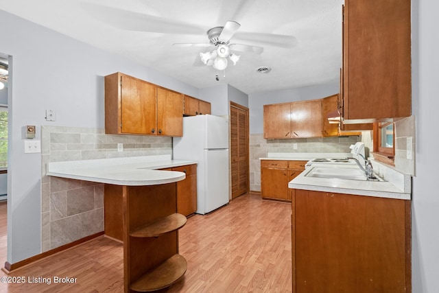 85 Joseph Ave, Cecilia, KY 42724 - kitchen with freestanding refrigerator, brown cabinetry, light wood-type flooring, and ceiling fan